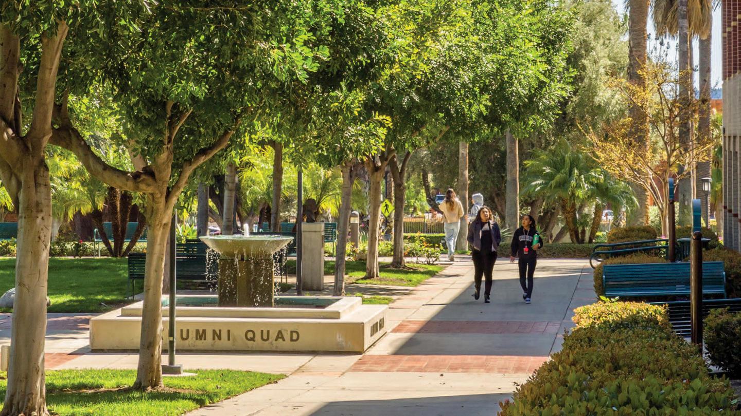 Two students walking and talking across the Woodbury Campus in Burbank.