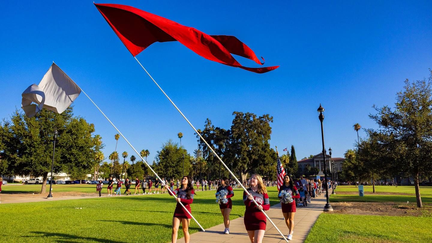 Media masthead - Flags and banners at new student orientation convocation event