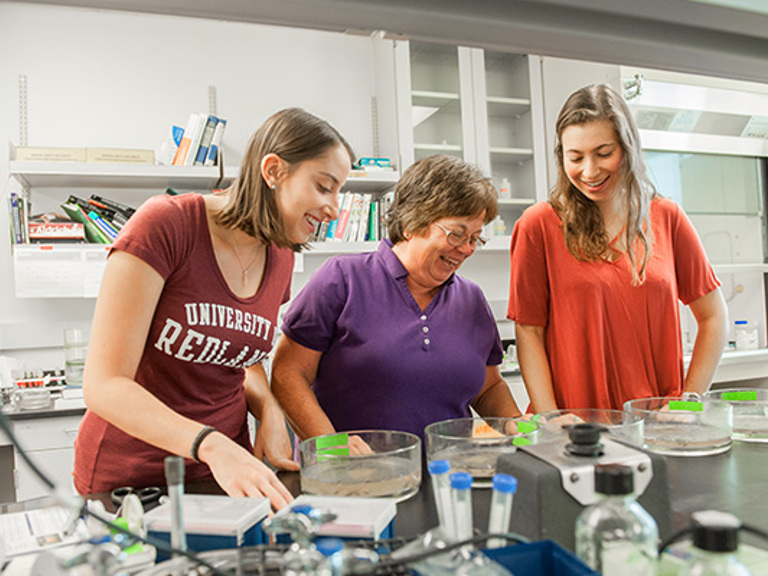 students-learning-with-faculty-in-science-lab