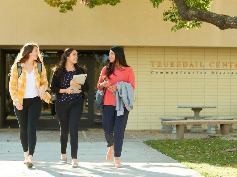 Media masthead - Communication disorders students walking out of Truesdail center