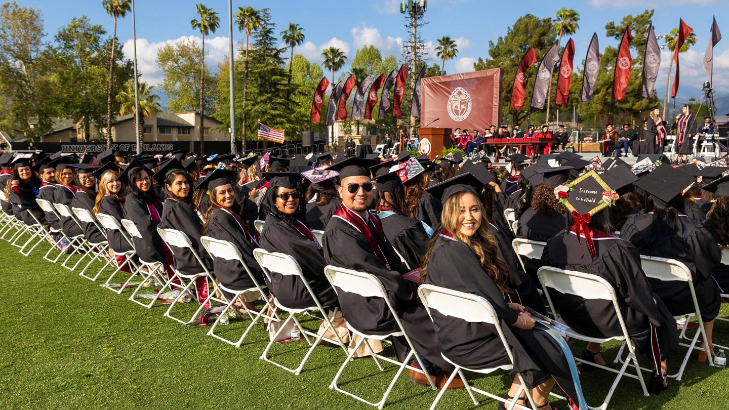 Row of students smiling for photo during Commencement.