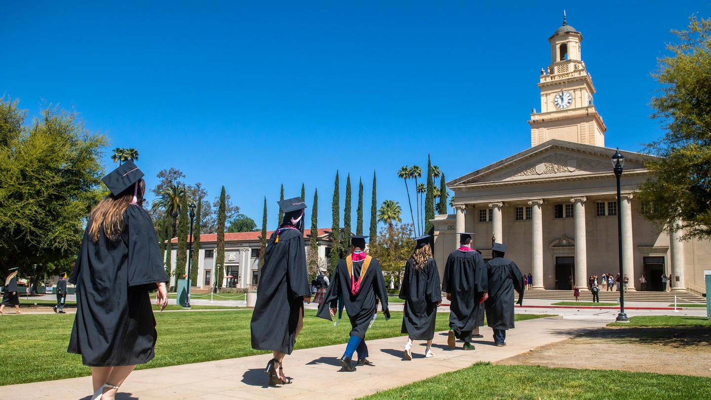 Students walking toward the Memorial Chapel during graduation.