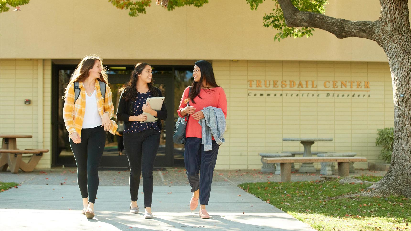 Media masthead - Communication disorders students walking out of Truesdail center