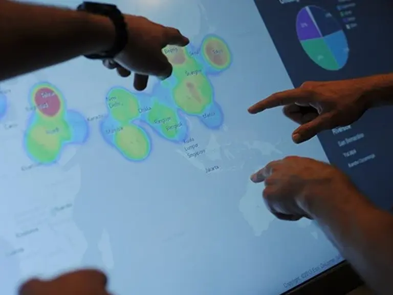 spatial-studies-minor-students-pointing-at-a-digital-map