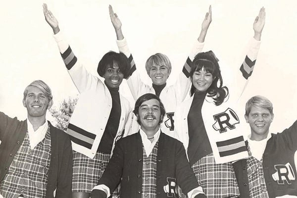 A cheer team with hands outstretched