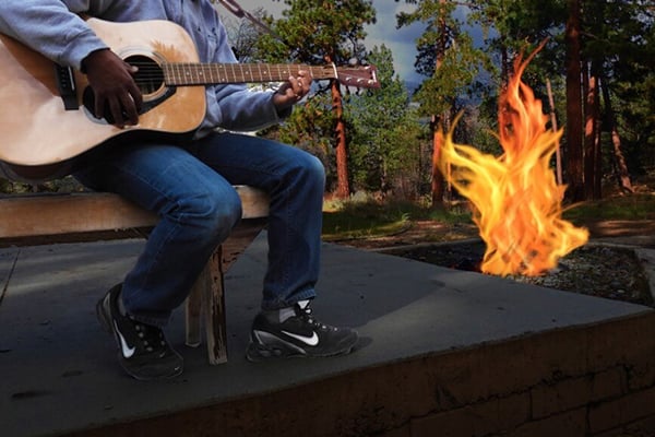 Guitar player by campfire.jpg